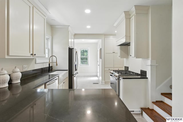 2525 N 55th St, Omaha, NE 68104 - kitchen featuring stainless steel appliances, dark countertops, recessed lighting, and white cabinetry
