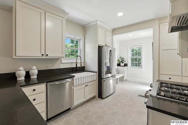 2525 N 55th St, Omaha, NE 68104 - kitchen with stainless steel appliances, dark countertops, recessed lighting, exhaust hood, and light tile patterned flooring