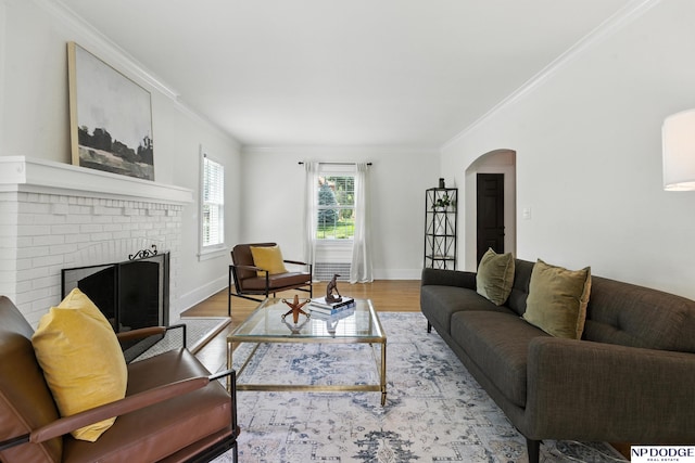 2525 N 55th St, Omaha, NE 68104 - living area featuring arched walkways, ornamental molding, wood finished floors, and a brick fireplace