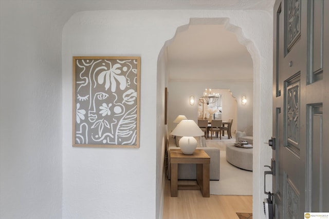2518 N 56th St, Omaha, NE 68104 - corridor with arched walkways, light wood-type flooring, and a chandelier