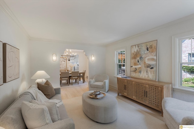 2518 N 56th St, Omaha, NE 68104 - living room with a chandelier, ornamental molding, healthy amount of natural light, and light wood-type flooring