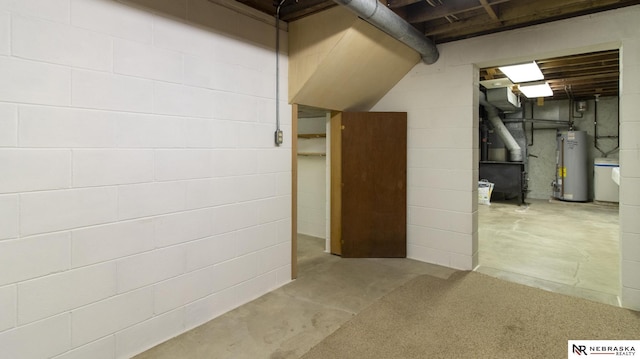 590 Tyler St, Bennet, NE 68317 - below grade area featuring water heater and concrete block wall