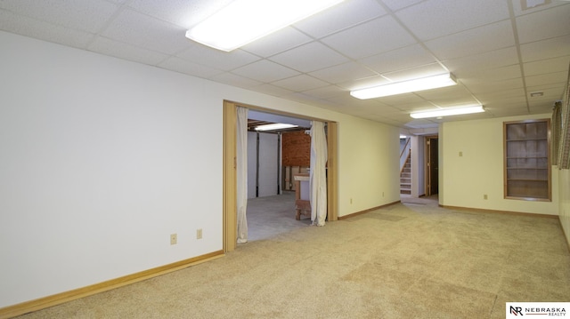 590 Tyler St, Bennet, NE 68317 - spare room featuring carpet floors, stairs, and a paneled ceiling