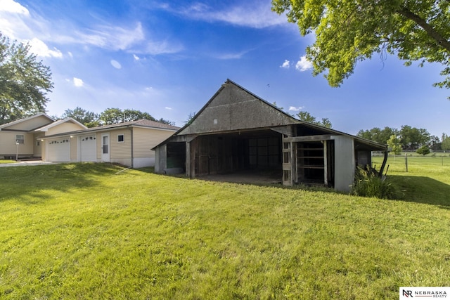 590 Tyler St, Bennet, NE 68317 - view of pole building with a lawn and a garage