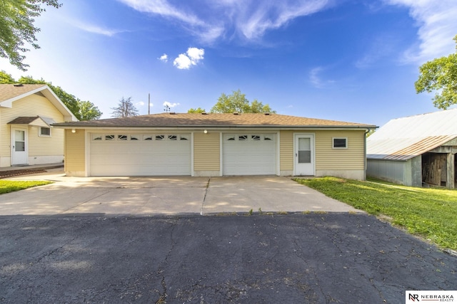 590 Tyler St, Bennet, NE 68317 - view of front of house featuring an outdoor structure and a garage