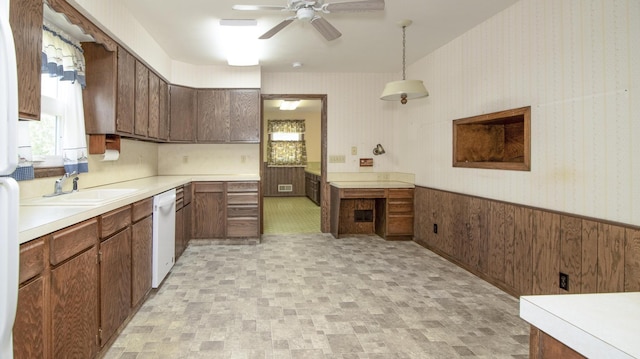 590 Tyler St, Bennet, NE 68317 - kitchen featuring white dishwasher, ceiling fan, a wainscoted wall, light countertops, and pendant lighting