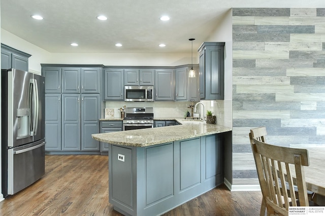 1622 S 179th St, Omaha, NE 68130 - kitchen with stainless steel appliances, a peninsula, gray cabinets, light stone countertops, and recessed lighting
