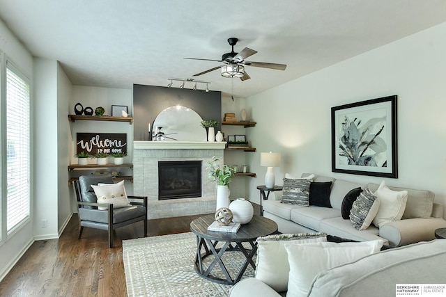 1622 S 179th St, Omaha, NE 68130 - living area with ceiling fan, a glass covered fireplace, wood finished floors, and rail lighting