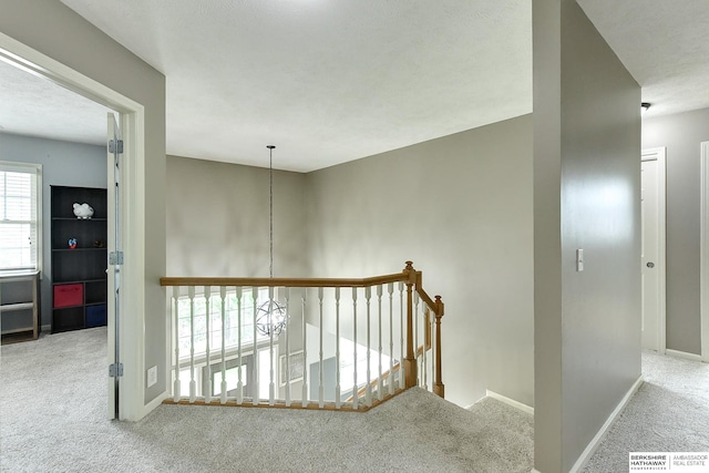 1622 S 179th St, Omaha, NE 68130 - corridor featuring carpet flooring, an upstairs landing, and a chandelier