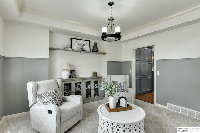 1622 S 179th St, Omaha, NE 68130 - carpeted living area featuring a raised ceiling, a chandelier, and crown molding