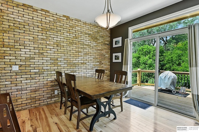 408 S 197th St, Omaha, NE 68022 - dining room featuring brick wall and light wood finished floors