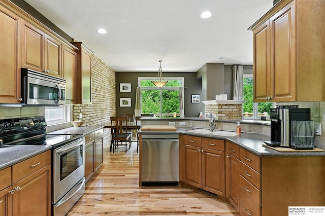 408 S 197th St, Omaha, NE 68022 - kitchen featuring appliances with stainless steel finishes, light wood-type flooring, brown cabinetry, backsplash, and recessed lighting
