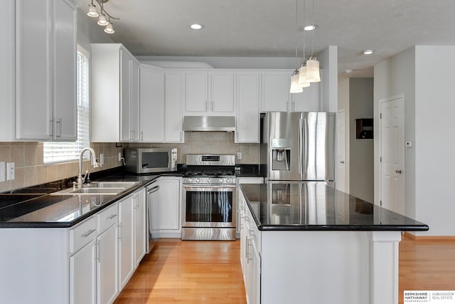 16332 Patrick Ave, Omaha, NE 68116 - kitchen featuring stainless steel appliances, under cabinet range hood, light wood finished floors, white cabinetry, and recessed lighting
