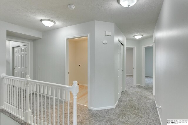 16332 Patrick Ave, Omaha, NE 68116 - corridor with an upstairs landing, carpet, and a textured ceiling