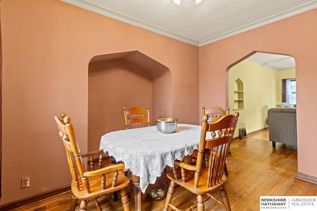 5101 Maple St, Omaha, NE 68104 - dining area with arched walkways, ornamental molding, and wood finished floors