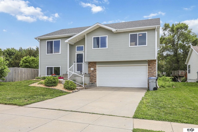 155 Vince Dr, Bennet, NE 68317 - split foyer home featuring stone siding, a garage, concrete driveway, and a shingled roof