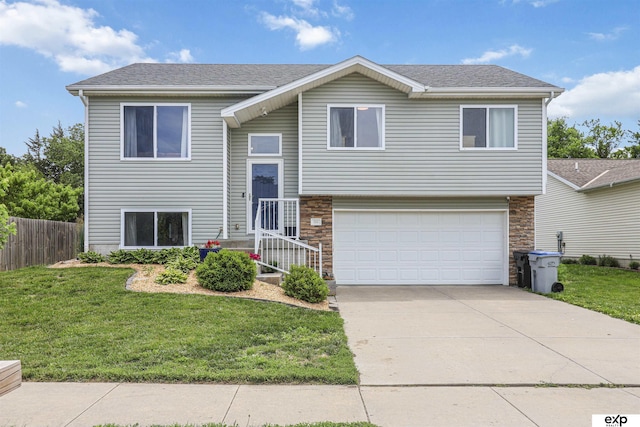 155 Vince Dr, Bennet, NE 68317 - bi-level home with a garage, stone siding, driveway, and a shingled roof