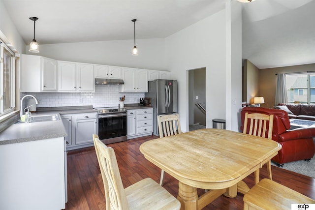 155 Vince Dr, Bennet, NE 68317 - kitchen featuring appliances with stainless steel finishes, under cabinet range hood, decorative backsplash, white cabinets, and decorative light fixtures