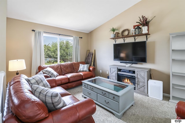 155 Vince Dr, Bennet, NE 68317 - carpeted living area with a glass covered fireplace and lofted ceiling