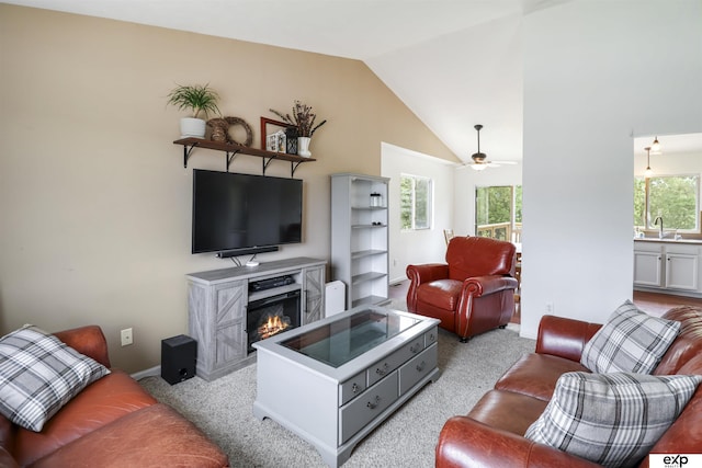 155 Vince Dr, Bennet, NE 68317 - living room with a glass covered fireplace, vaulted ceiling, light colored carpet, and ceiling fan