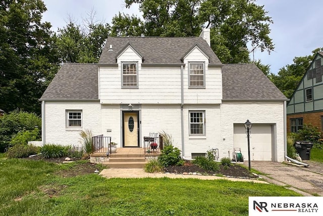 3340 N 48th Ave, Omaha, NE 68104 - view of front of house featuring a chimney, asphalt driveway, an attached garage, a shingled roof, and a front lawn