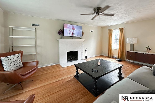 3340 N 48th Ave, Omaha, NE 68104 - living area featuring a ceiling fan, a fireplace, and light wood-style floors