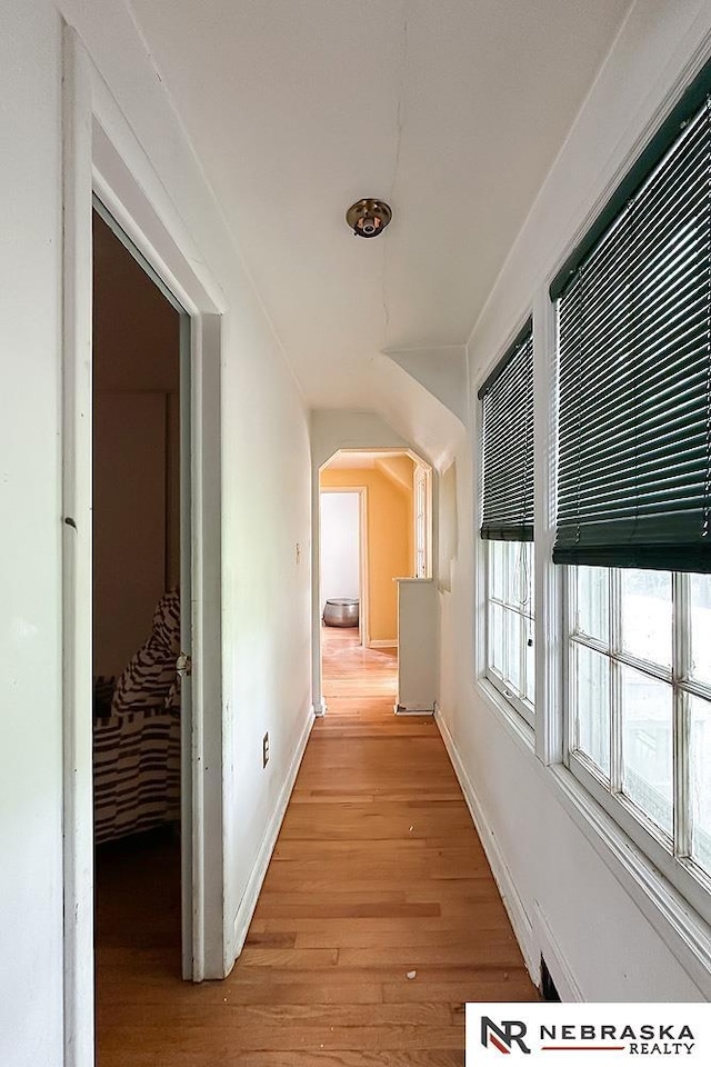 3340 N 48th Ave, Omaha, NE 68104 - corridor with light wood-style floors and arched walkways