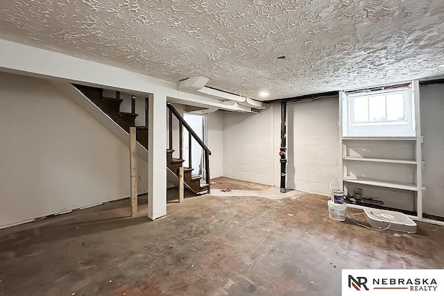 3340 N 48th Ave, Omaha, NE 68104 - below grade area with stairway and a textured ceiling