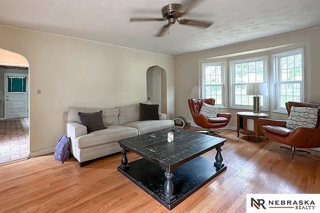 3340 N 48th Ave, Omaha, NE 68104 - living room with arched walkways, a ceiling fan, and light wood finished floors