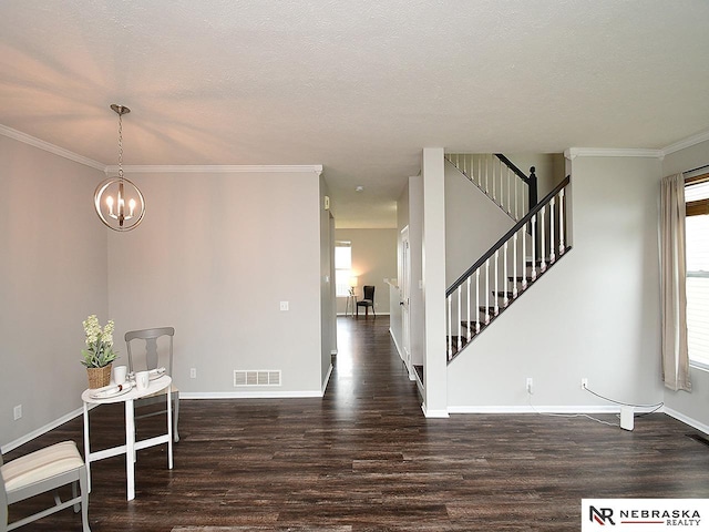 2906 Bar Harbor Dr, Bellevue, NE 68123 - foyer with wood finished floors, a chandelier, ornamental molding, stairway, and a textured ceiling