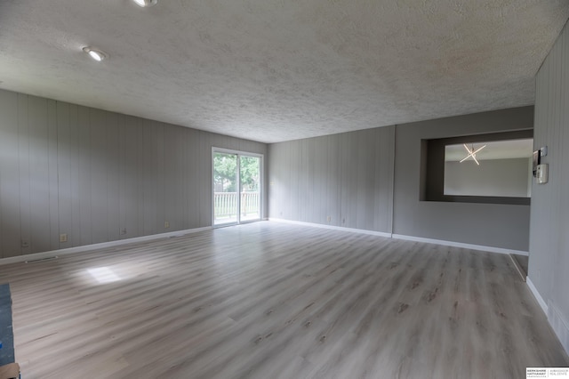 3701 Groves Rd, Bellevue, NE 68147 - empty room with wood finished floors and a textured ceiling