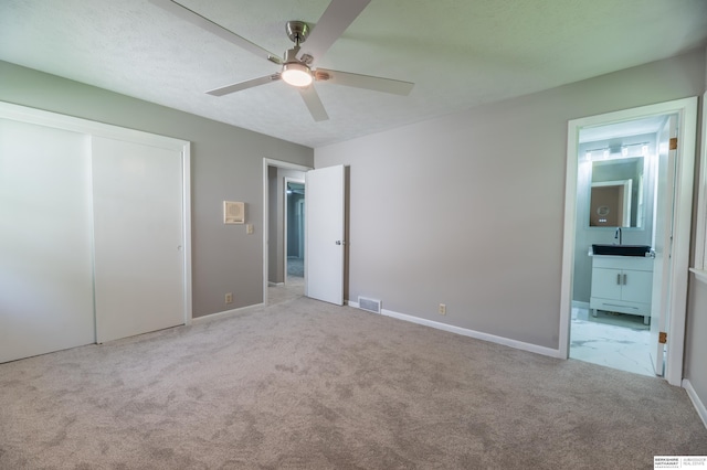 3701 Groves Rd, Bellevue, NE 68147 - unfurnished bedroom with carpet, ensuite bath, a closet, and a ceiling fan