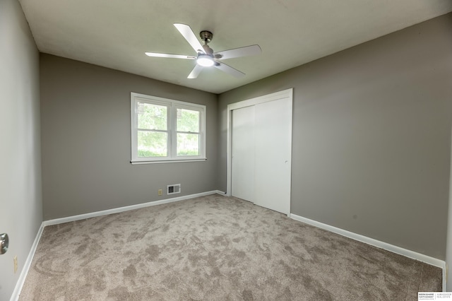 3701 Groves Rd, Bellevue, NE 68147 - unfurnished bedroom with carpet, a closet, and a ceiling fan