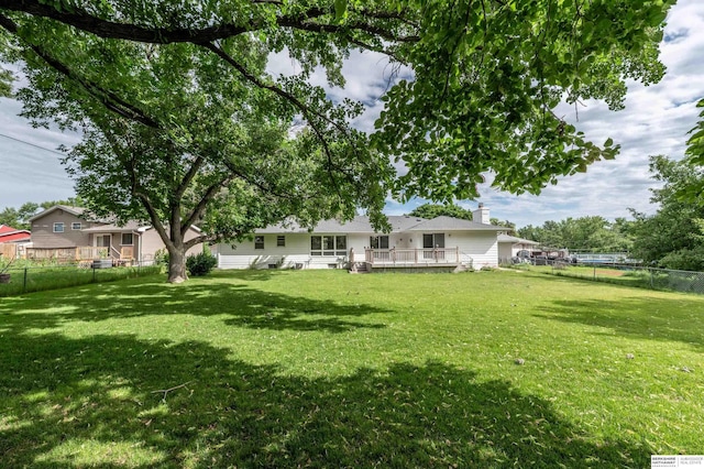 3701 Groves Rd, Bellevue, NE 68147 - back of property featuring a fenced backyard, a chimney, and a deck