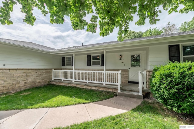 3701 Groves Rd, Bellevue, NE 68147 - property entrance with a porch and a yard