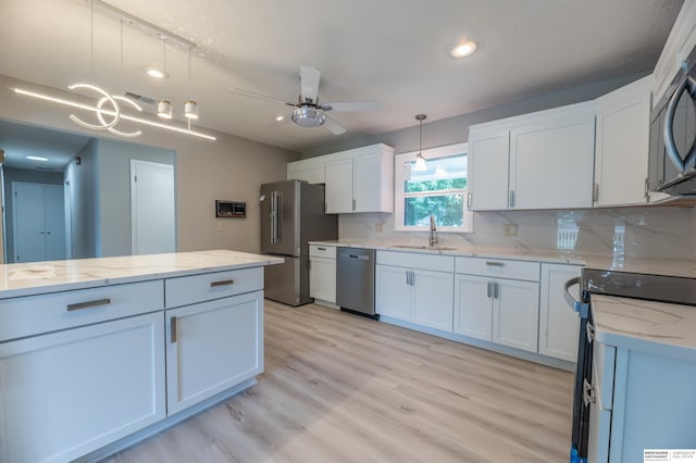 3701 Groves Rd, Bellevue, NE 68147 - kitchen featuring appliances with stainless steel finishes, a ceiling fan, light wood-type flooring, white cabinetry, and recessed lighting