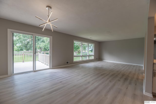 3701 Groves Rd, Bellevue, NE 68147 - spare room with light wood-type flooring and a chandelier