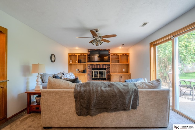 12312 Decatur St, Omaha, NE 68154 - living room featuring carpet flooring, a brick fireplace, and a ceiling fan