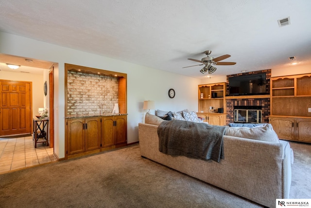 12312 Decatur St, Omaha, NE 68154 - living room featuring light carpet, ceiling fan, and a brick fireplace