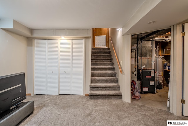 12312 Decatur St, Omaha, NE 68154 - finished basement featuring stairway, carpet floors, and gas water heater