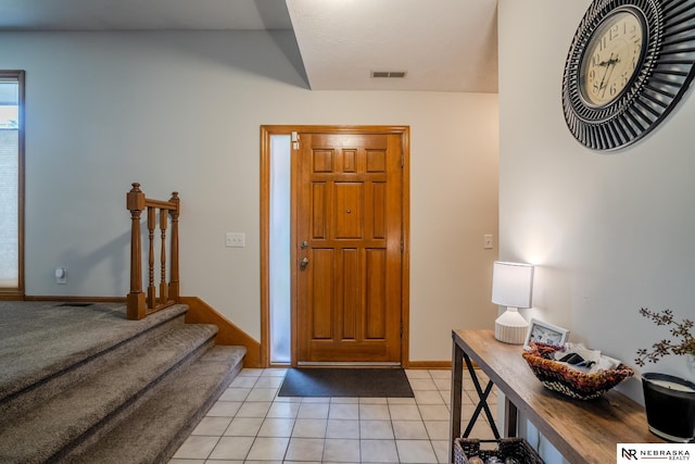 12312 Decatur St, Omaha, NE 68154 - entryway featuring light tile patterned floors and baseboards
