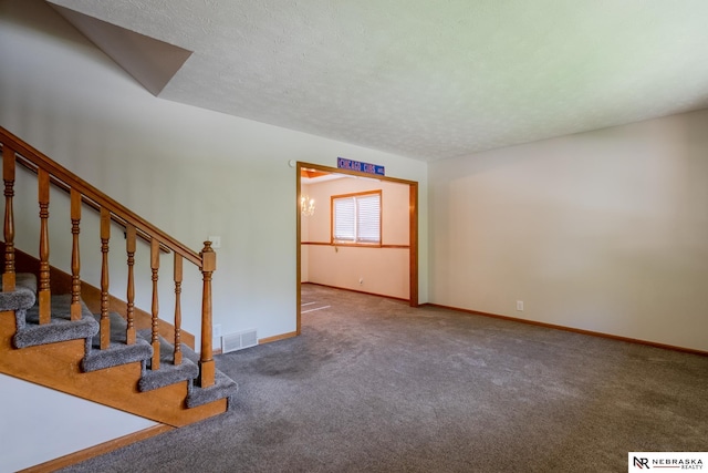 12312 Decatur St, Omaha, NE 68154 - unfurnished living room with carpet, stairway, and a textured ceiling
