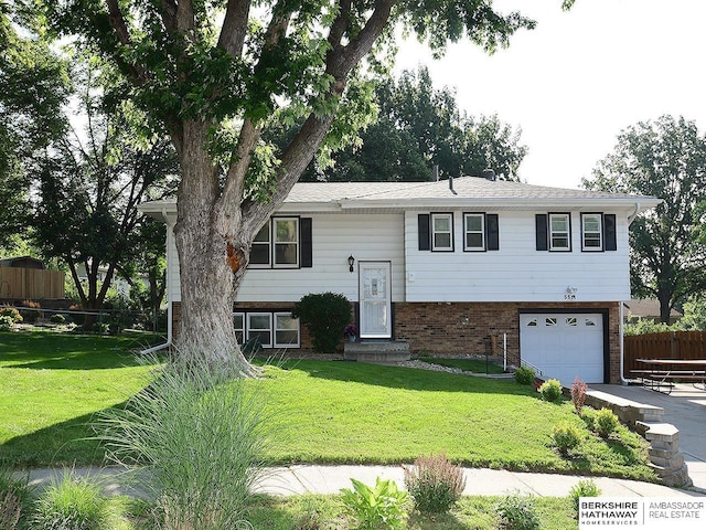 5511 S 104th Cir, Omaha, NE 68127 - split foyer home featuring an attached garage and brick siding
