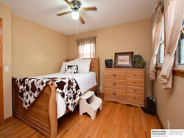 5511 S 104th Cir, Omaha, NE 68127 - bedroom with light wood-style flooring and a ceiling fan