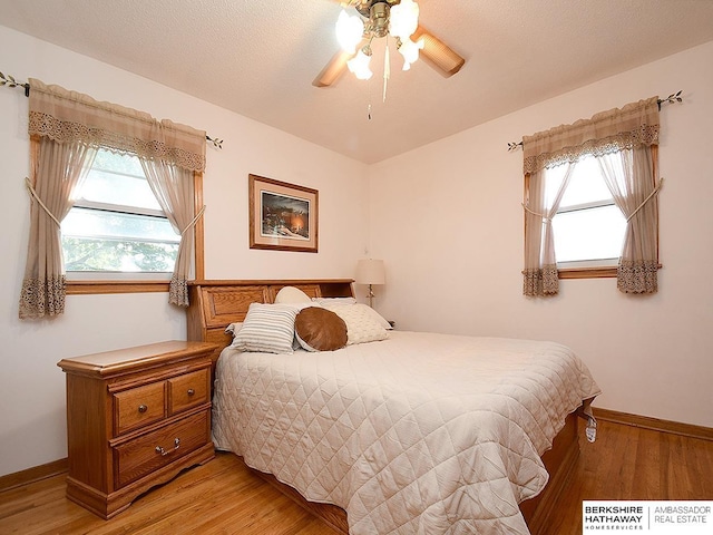 5511 S 104th Cir, Omaha, NE 68127 - bedroom with light wood finished floors and a ceiling fan