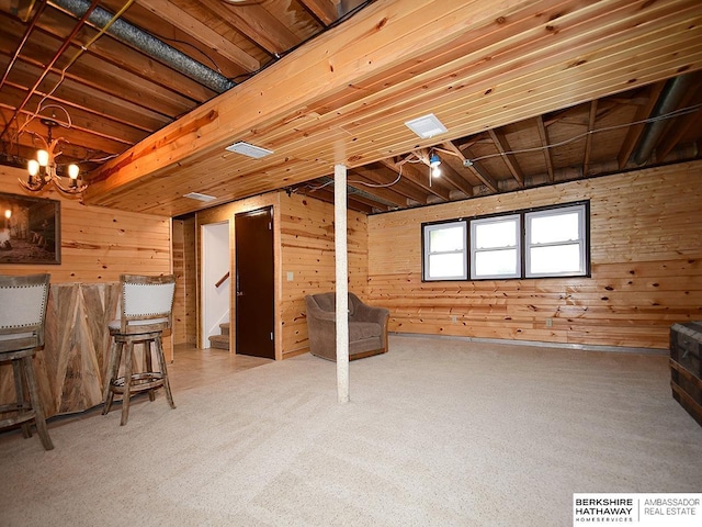 5511 S 104th Cir, Omaha, NE 68127 - basement with wooden walls, stairs, carpet floors, and a chandelier