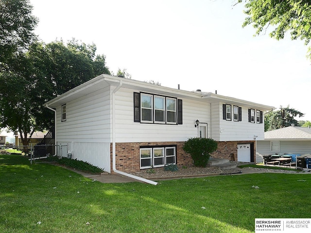5511 S 104th Cir, Omaha, NE 68127 - raised ranch with brick siding and a garage