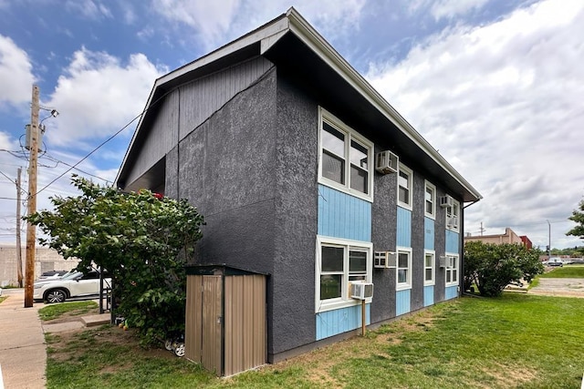 5125 Marshall Dr, Omaha, NE 68137 - view of side of home featuring a lawn, cooling unit, and an AC wall unit