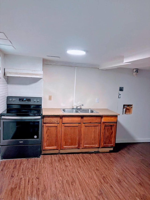 2715 S 15th St, Omaha, NE 68108 - kitchen featuring electric range, light wood-style flooring, brown cabinetry, and light countertops