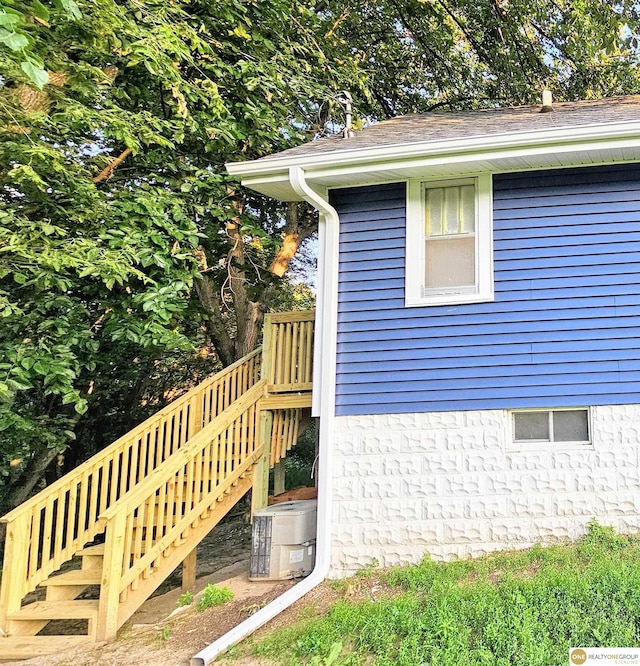 2715 S 15th St, Omaha, NE 68108 - view of side of property with stairway and roof with shingles